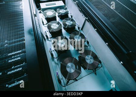 This image showcases an advanced cooling system featuring multiple fans designed to enhance airflow for critical technology equipment in a server envi Stock Photo