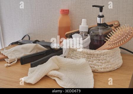 Hair care and beauty essentials arranged on a wooden table, emphasizing daily grooming Stock Photo