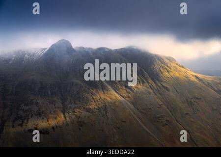 Moody skies above The Langdale Pikes on a winter afternoon seen from Bowfell, Lake District, UK. Stock Photo