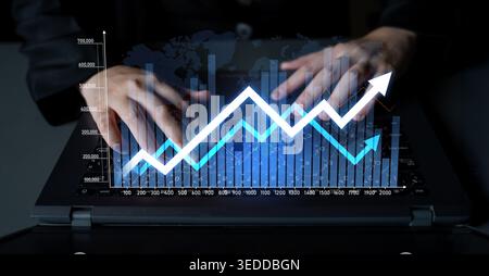 A business professional hands work on a laptop displaying a vibrant digital graph. The image captures the essence of data analysis and financial Stock Photo