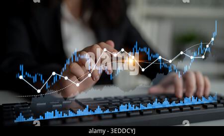 A business professional engages in data analysis, displaying graphs and financial metrics on a computer screen, emphasizing growth and market insights Stock Photo