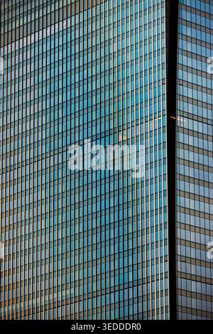 Shiny glass facade of modern high-rise building in Marunouchi business district, Chiyoda City, Tokyo, Japan. Stock Photo