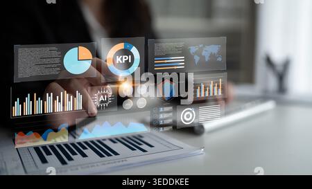 A business professional engages with a digital dashboard displaying key performance indicators, charts, and analytics in a modern office setting Stock Photo