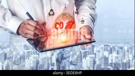 Person in White Shirt Using Digital Tablet to Promote Environmental Awareness with CO2 Footprint and Eco Symbols Against City Background Quark. Stock Photo