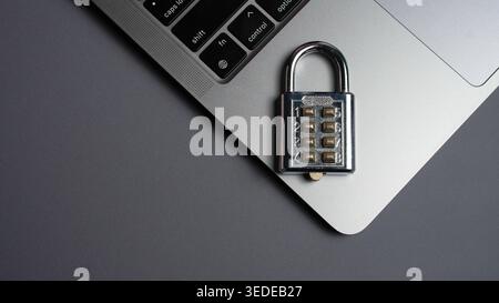 Metal Combination Padlock on Laptop Keyboard for Cyber Security Data Privacy and Online Safety Concept Stock Photo
