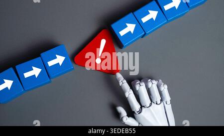 Robot Hand Touching a Red Warning Triangle Symbol on Gray Background Concept of Artificial Intelligence Error Handling and Risk Management Stock Photo