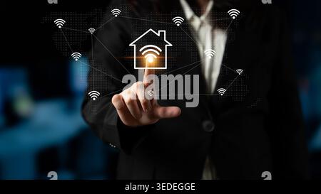 A business professional interacts with smart home technology, emphasizing modern connectivity and innovative management solutions for digital home Stock Photo