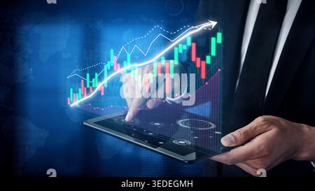 A business professional interacts with a digital tablet showcasing stock market trends and financial analytics, illustrating modern investment Stock Photo