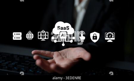 A business professional showcases the concept of SaaS and AI in a modern office. The image features technology icons that represent digital solutions Stock Photo