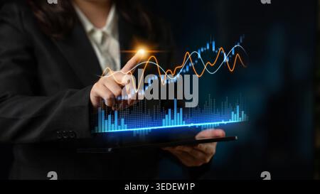 A business professional explores financial data on a tablet, displaying a vibrant digital graph. Ideal for themes of finance, growth, and analytics in Stock Photo