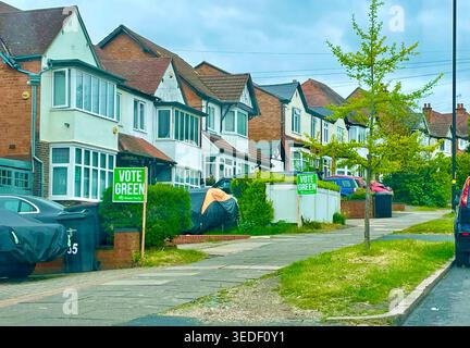 A residential street with signs up for election campaigning for the Green Party Stock Photo