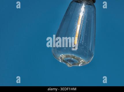 An outdoor light bulb against a clear blue sky Stock Photo