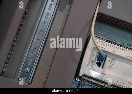 Closeup view of an electrical panel showcasing wiring connections and electronic components, highlighting the importance of safety and technology in m Stock Photo