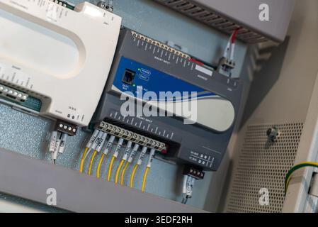 Close-up of an industrial control panel showcasing intricate wiring and electronic components essential for automation and operational efficiency. Stock Photo