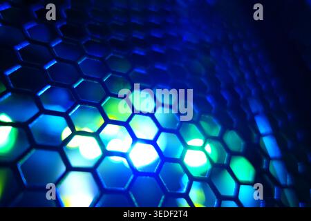 This image features a close-up view of a hexagonal pattern illuminated by blue light, creating a vibrant and modern abstract design suitable for vario Stock Photo