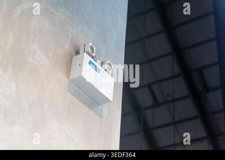 Wall-mounted emergency light system with dual lamps providing essential illumination and safety alert features in indoor spaces for effective emergenc Stock Photo