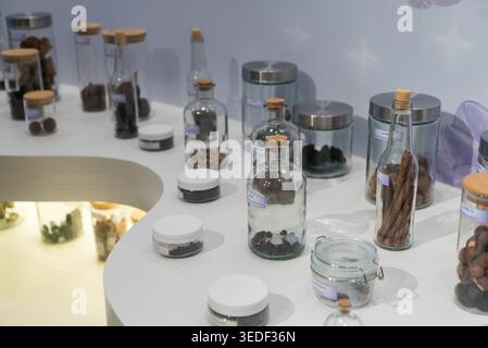 A visually appealing display of assorted herbs and spices in glass containers on a sleek countertop, showcasing various culinary ingredients for cooki Stock Photo
