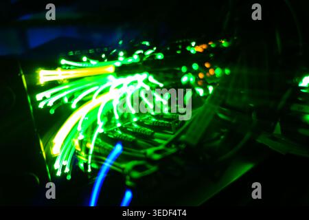 A vibrant display of fiber optic cables showcases their brilliance with flowing lights and colors, highlighting the technology behind modern data tran Stock Photo