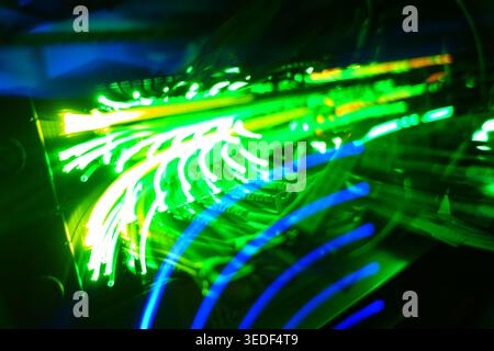 Abstract neon lights illuminate intricate circuitry, creating a dynamic visual of technology and energy, perfect for digital and modern themes. Stock Photo