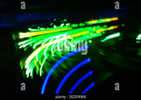 An abstract representation of colorful light trails capturing movement and energy. This vibrant image showcases the beauty of illumination in a modern Stock Photo