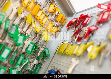 A vibrant array of keys organized on a display board. This closeup captures the various colors and styles, showcasing practical storage solutions for Stock Photo