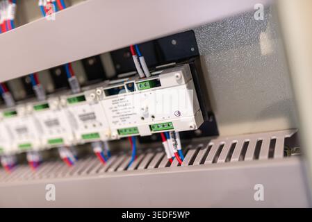 Detailed view of an electrical control panel showcasing circuit components and connections. Ideal for topics on industrial technology and engineering Stock Photo