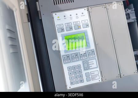 A close-up view of a modern control panel featuring a digital display, buttons, and user interface used in various industrial applications for equipme Stock Photo