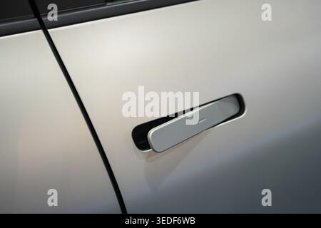 Close-up of a flush car door handle integrated into modern vehicle body, showcasing sleek design and aerodynamic styling Stock Photo