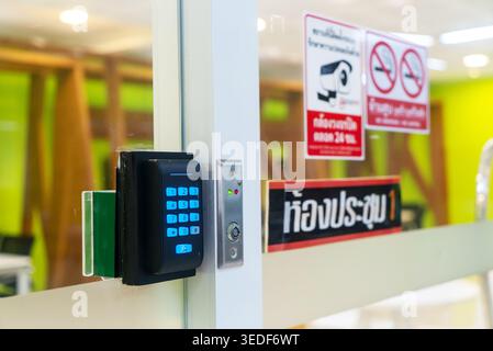 This image showcases a modern security system featuring a keypad and card reader at an office entrance. With surveillance options and strong safety me Stock Photo