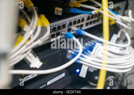 Close-up image of network equipment displaying connected cables and ports. This visual represents modern technology for data communication and managem Stock Photo