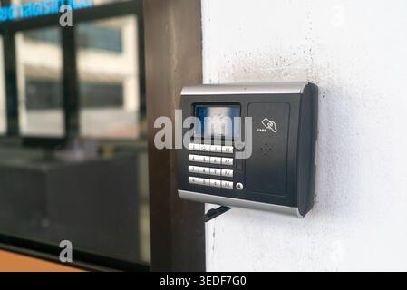 A close-up view of a modern intercom system mounted on a wall. This electronic device offers secure access control and communication for buildings or Stock Photo