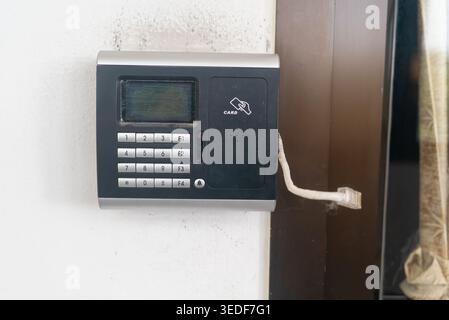 A modern intercom system designed for secure access features a keypad, display screen, and connection for audio communication, suitable for homes and Stock Photo