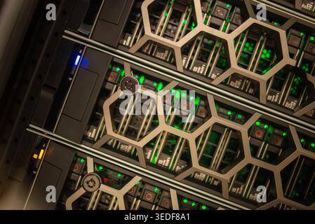 A close-up view of a modern data center rack displaying illuminated components, showcasing high-performance computing and efficient data management te Stock Photo