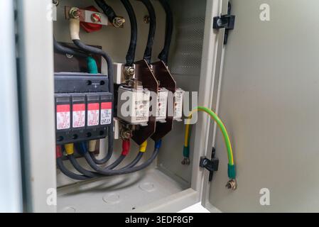 Close-up view of electrical components inside a control panel. The image features circuit breakers and wiring, showcasing installation and electrical Stock Photo