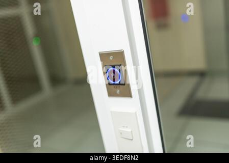 Close-up of a modern elevator control panel showcasing a sleek design. Features illuminated button for efficient navigation in contemporary spaces. Stock Photo