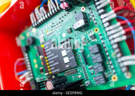 Close-up view of a complex electronic circuit board showcasing various components and connections. Perfect for technology and engineering topics. Stock Photo