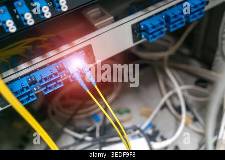 Close-up view of fiber optic cables connecting to networking equipment, highlighting data transfer and communication technology in a modern network se Stock Photo