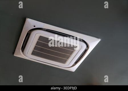 This image showcases a sleek ceiling-mounted air conditioning unit, highlighting its modern design and functionality for indoor climate control. Stock Photo