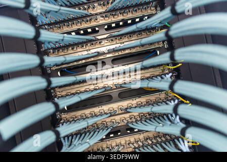 A close-up view of network cables and connectors inside a data center, showcasing the intricate layout of wiring used for data transmission and connec Stock Photo