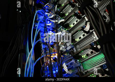 A close-up view of a colorful server rack showcasing multiple cables and illuminated components, representing technology infrastructure in a modern da Stock Photo