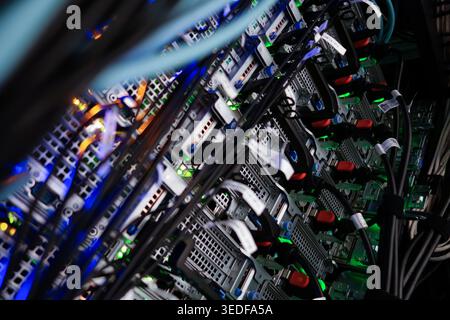 A vibrant server room showcasing multiple server racks with colorful fiber optic cables. The scene captures the essence of modern technology and data Stock Photo