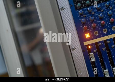 A close-up view of a digital sound mixer control panel featuring colorful knobs and buttons. This image highlights the intricate details of audio equi Stock Photo