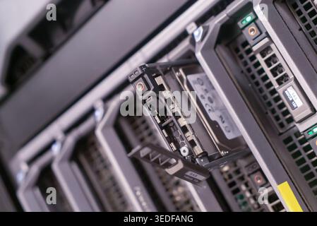 A close-up of a server rack displaying an opened hard disk drive bay, showcasing advanced technology in data storage and computing infrastructure. Stock Photo