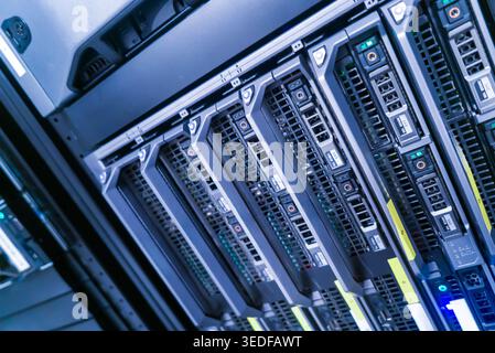 A close-up view of high-tech server racks in a modern data center. Explore the intricate details of hardware components, wiring, and cooling systems. Stock Photo