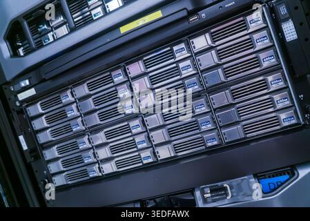 A close-up view of a storage server featuring multiple hard drives. This image represents modern data management, showcasing technology for enterprise Stock Photo