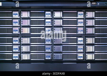 A detailed view of a high-performance server rack featuring multiple storage drives. This image showcases advanced technology used in data management Stock Photo