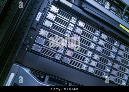 A close-up view of a server rack displaying multiple storage units, showcasing modern technology and infrastructure essential for data management and Stock Photo