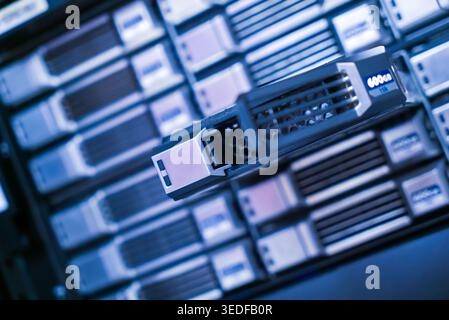 Close-up view of data server equipment in a modern technology space. This image showcases advanced storage solutions and networking hardware used in d Stock Photo