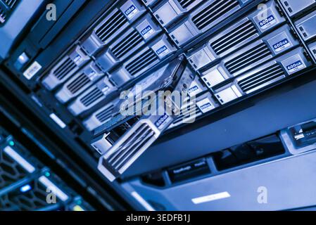 A close view of a high-tech data storage server featuring a disk drive. This image highlights the advanced technology used in modern data centers for Stock Photo