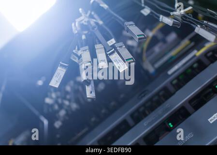 Close-up view of various connectors and cables in a data center. The image illustrates modern technology used for networking and data transfer. Stock Photo
